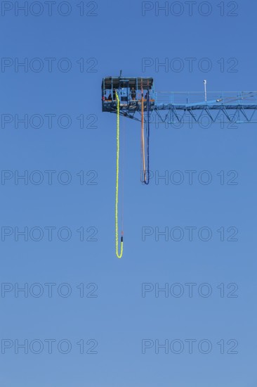 Montreal Bungee Tower installation with dangling long yellow elastic bungee jumping cord, Old Port