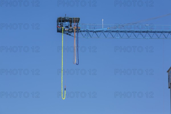 Montreal Bungee Tower installation with dangling long yellow elastic bungee jumping cord, Old Port