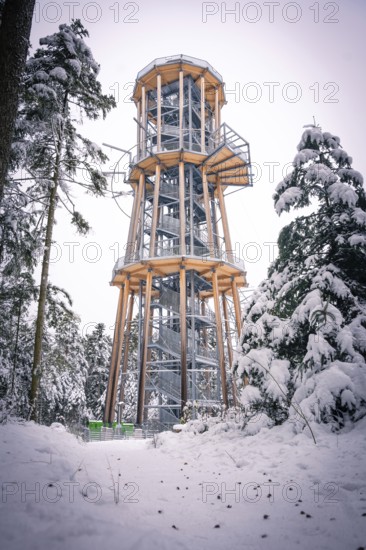 A snowy treetop trail against a winter sky under snow-covered trees, Himmelsglück observation tower