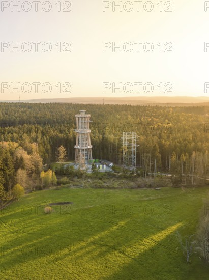 Tower in open area with forests at sunset, sky in evening light, observation tower Himmelsglück