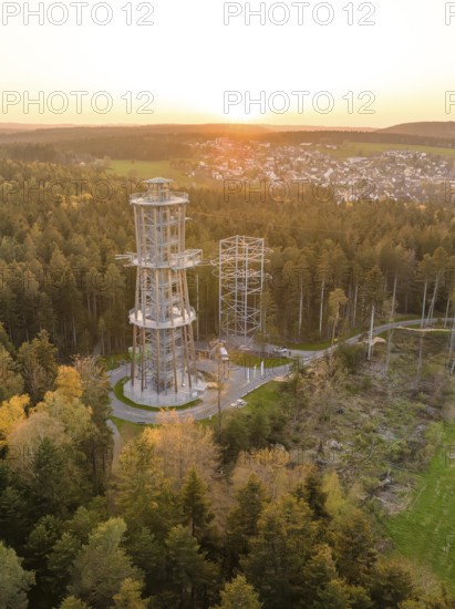 Tower in the forest at sunset, a village visible in the distance, Himmelsglück observation tower