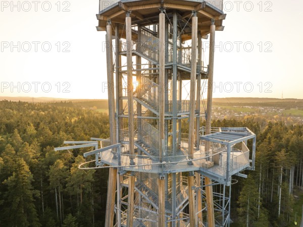 Metal observation tower at sunset surrounded by thick forests, Himmelsglück observation tower with