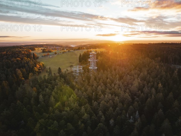 Sunset behind an observation tower in the middle of a vast forest, Himmelsglück observation tower
