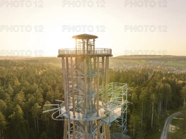 Detailed view of a modern tower, sunlight penetrating the structure in a forest, Himmelsglück