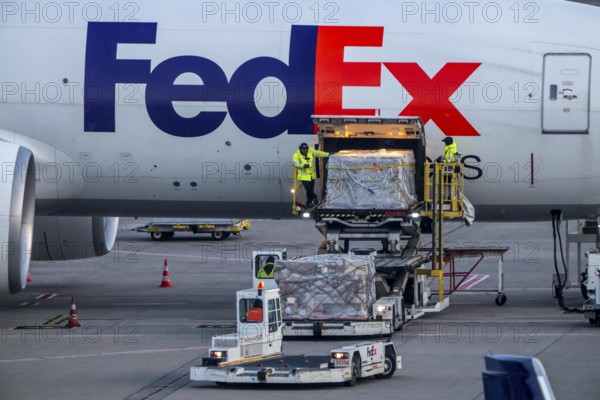 FedEx Express Boeing 777-FS2 cargo plane is unloaded, air freight container, air freight center at