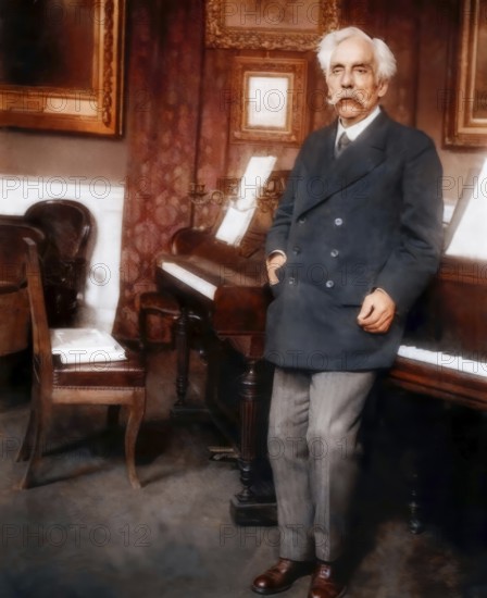 Gabriel Fauré, 1845 – 1924, French composer, next to his piano in his appartement, Boulevard