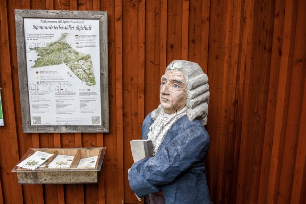 Wooden statue of botanist and founder of the binary nomenclature Carl von Linné with white hair and
