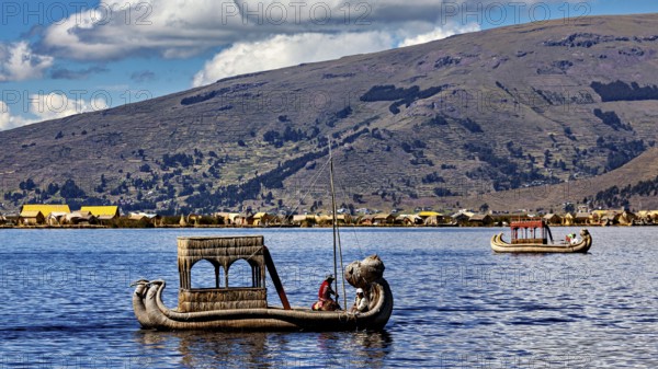 Two reed boats on a lake surrounded by mountains and a clear sky, The floating reed islands of the