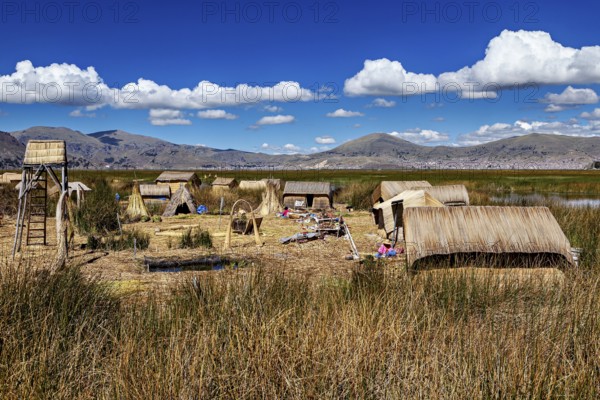 Extensive reed village in a natural setting with mountains, the floating reed islands of the Uros