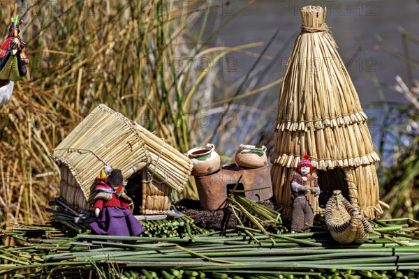 Miniature huts and figures made of straw and clay on a natural support, The floating reed islands