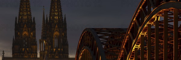 Evening atmosphere, Cologne Cathedral illuminated with LED lamps and the Hohenzollern Bridge,