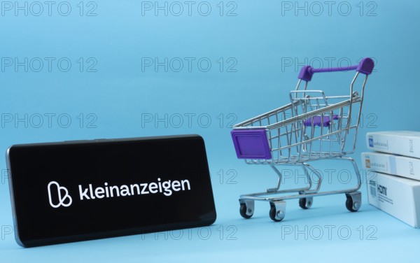 Dhaka, Bangladesh- 03 July 2025: Smartphone with Kleinanzeigen logo next to a small shopping cart