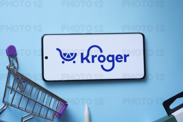 Dhaka, Bangladesh- 03 July 2025: Smartphone displaying Kroger logo with shopping cart on a blue