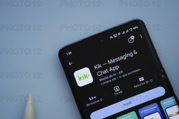Dhaka, Bangladesh- 29 May 2025: On a blue surface, a smartphone displays the Kik app within the