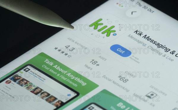 Dhaka, Bangladesh- 30 Oct 2025: Kik app on a iPad screen with a pen pointing at the install option