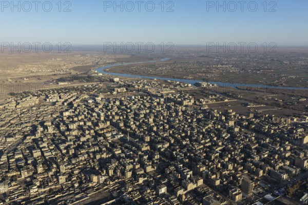 In Deir ez-Zor, Eastern Syria on January 21, 2026, an aerial drone shot captures the city landscape