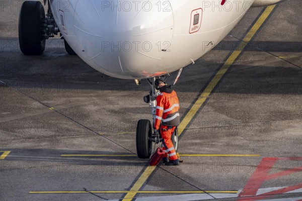 Ground crew positions brake blocks on the chassis, after stopping at the parking position, at the