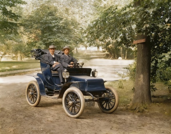 Thomas Alva Edison and William Billy Bee in Detroit Electric automobile on Edge Hill Avenue in
