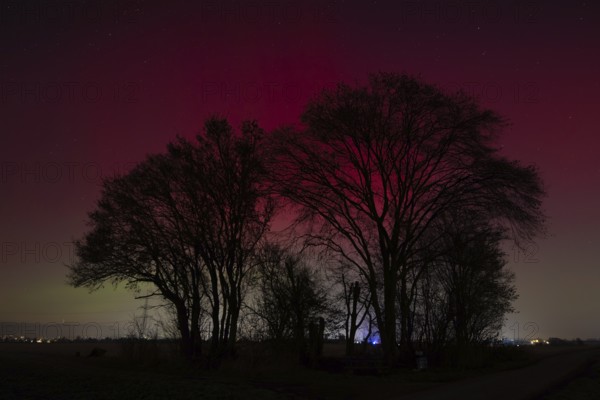 Northern lights (aurora borealis) glow red and green in the evening sky over Germany, Frankfurt am