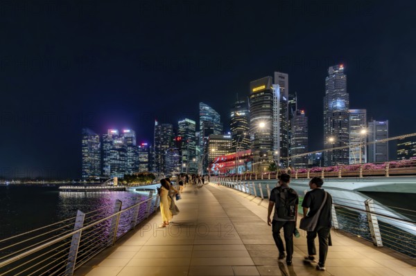 Skyline of the Central Business District, CBD with illuminated skyscrapers and Jubilee Bridge in