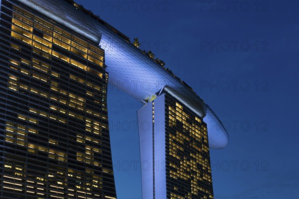 Marina Bay Sands, MBS, luxury 5-star hotel and integrated resort illuminated at dusk in Downtown