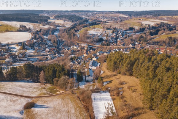 Extensive winter landscape with a village and surrounding fields under clear skies, Aach,