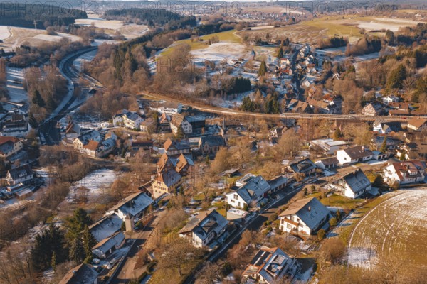 Snow-covered village spread over vast countryside with roads and forests, Aach, Dornstetten,