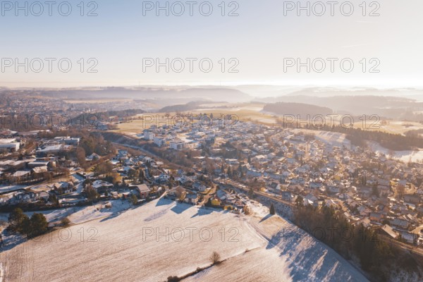 Aerial view of a snowy village in hilly landscape under bright sky, Aach, Dornstetten, Freudenstadt