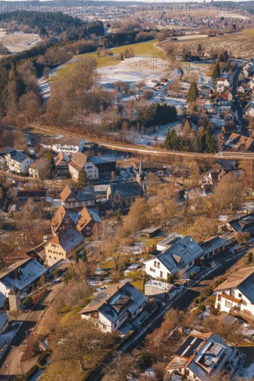 Snowy village in hilly surroundings taken from the air on a clear day, Aach, Dornstetten,