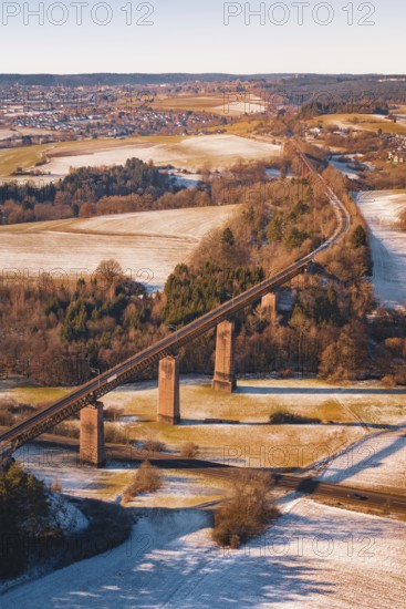 Railway bridge in winter surrounded by snow-covered fields and roads, Dornstetten, Freudenstadt