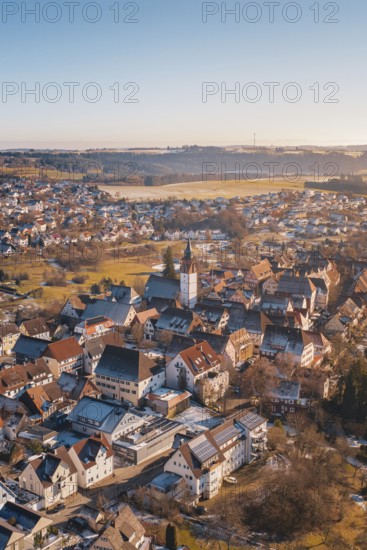 City view from the air with church architecture, surrounded by red roofs, in a winter landscape,