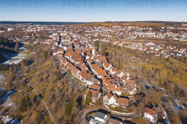 Aerial view of city in winter surroundings with characteristic red roofs, Dornstetten, Freudenstadt