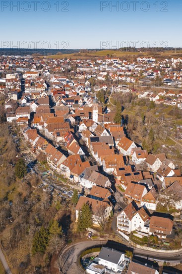 Aerial view of dense buildings with red roof tiles in a wintry environment, Dornstetten,
