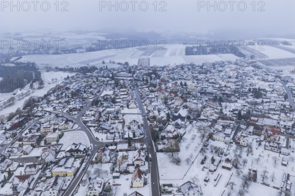 View of a snowy town and surrounding fields surrounded by grey sky, Empfingen, Freudenstadt