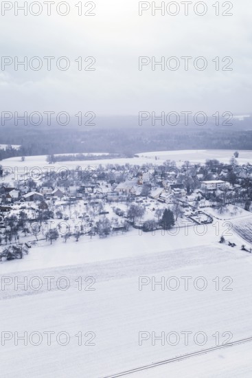 Snowy village in winter landscape with fields and trees, Wiesenstetten, Freudenstadt district,