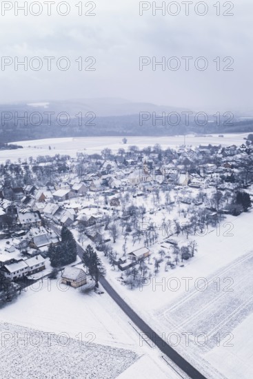 Snowy village surrounded by fields and trees in a wintry landscape, Wiesenstetten, Freudenstadt