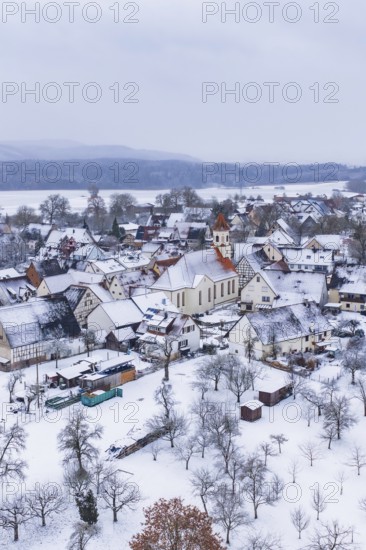 Village in winter with snow-covered houses and a church, cold atmosphere, Wiesenstetten,
