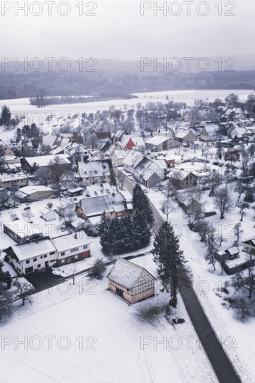 Wintery village with snow-covered houses and trees, cold landscape atmosphere, Wiesenstetten,