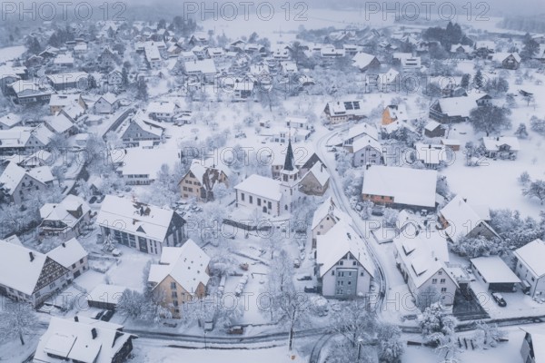 Snowy village with a church wrapped in a cold, peaceful atmosphere, Schopfloch, Freudenstadt