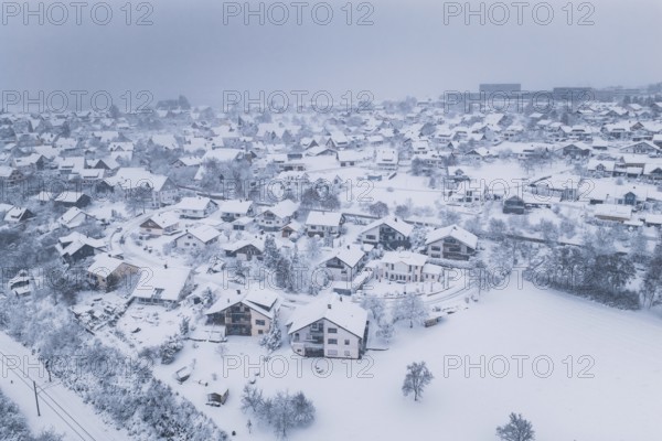 A village in winter rest, the houses are surrounded by snow and fog, Schopfloch, Freudenstadt