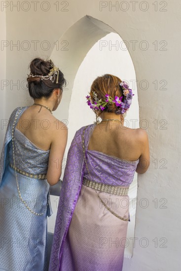 Young woman with traditional headdress, wearing traditional clothing, present themselves for the