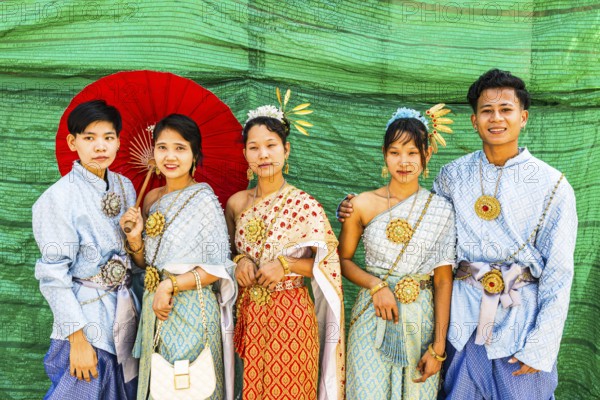 A group of young people wearing traditional clothing presents themselves for the photographers, Wat