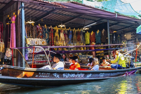 Wooden boat with tourists on the Damneon Saduak floating markets channel, near Bangkok, Ratchaburi
