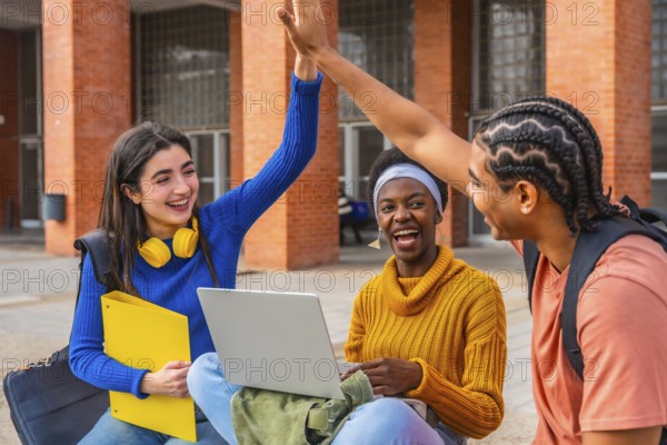 Diverse group of university students collaborating, celebrating a successful academic achievement