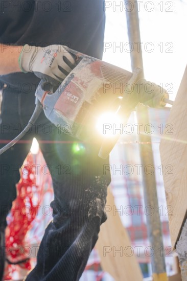 Drills and lighting effects on wood during construction work with construction workers, carpentry