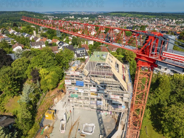 Large crane over a construction site with city panorama in the background, construction site of a