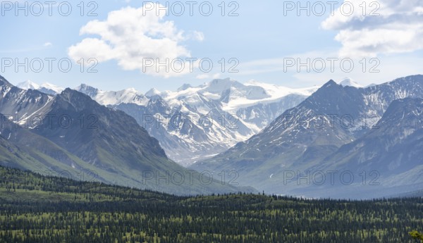 Taiga and tundra in front of mountain landscape, picturesque landscape with icy mountain peaks,