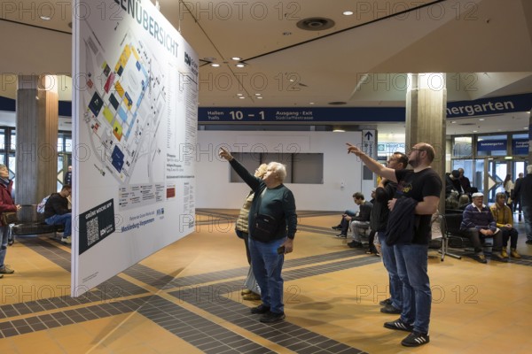 Visitors point to a map of the Green Week at the exhibition center in Berlin on 16.01.2026. The