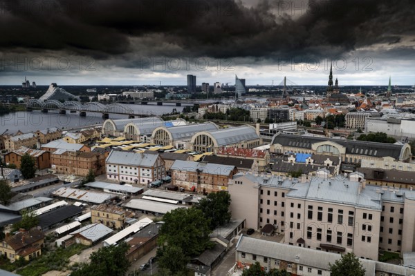 Dramatic city panorama of Riga with clouds above the Central Market, Riga, Latvia, Latvia