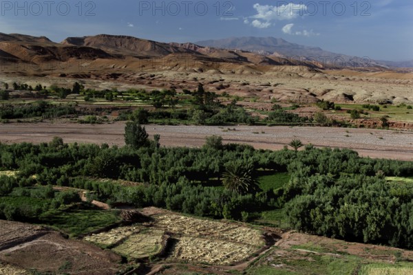 Extensive panoramic view of Ait Benhaddou with green valleys and surrounding mountains, Ait